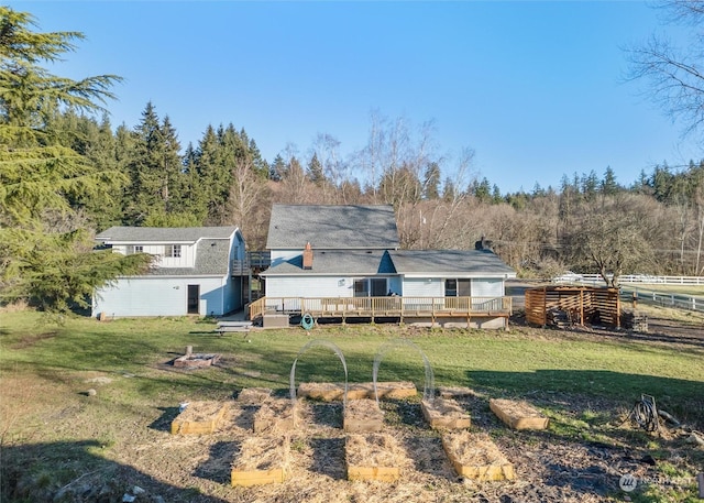 back of house featuring a yard and a deck