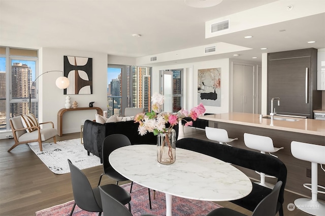 dining area featuring hardwood / wood-style floors and sink