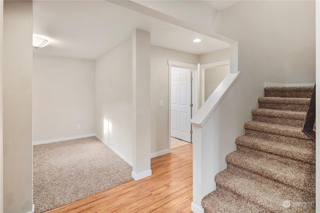 staircase featuring hardwood / wood-style floors