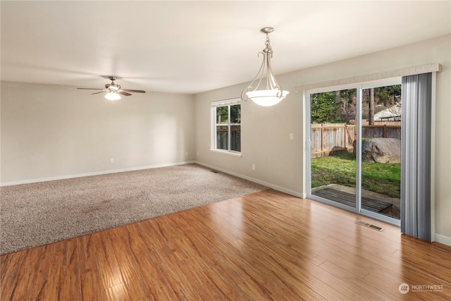 empty room with hardwood / wood-style flooring and ceiling fan