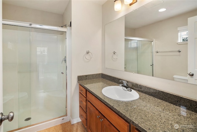 bathroom with an enclosed shower and vanity