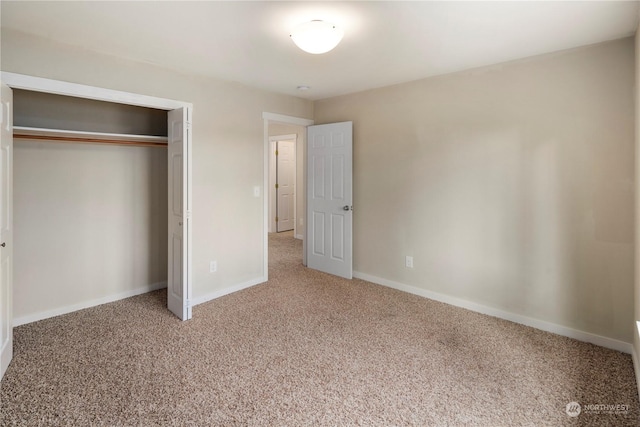 unfurnished bedroom with carpet floors and a closet