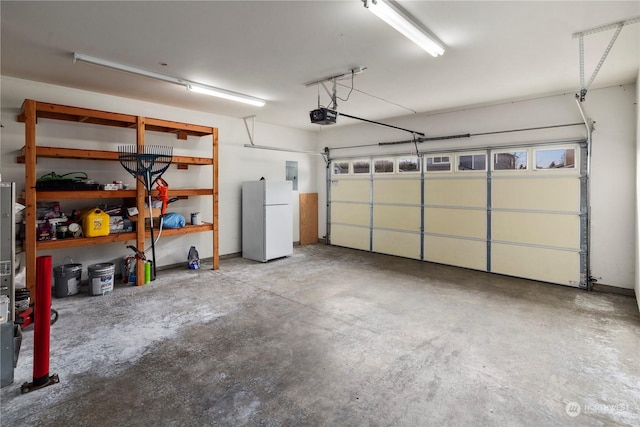 garage featuring a garage door opener, white refrigerator, and electric panel