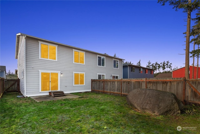 rear view of property with a patio and a yard