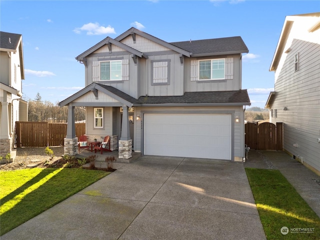 craftsman inspired home with a front yard and a garage