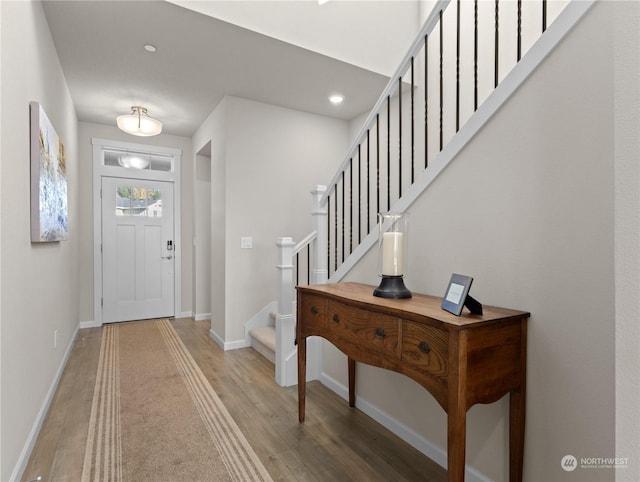 entryway with hardwood / wood-style floors