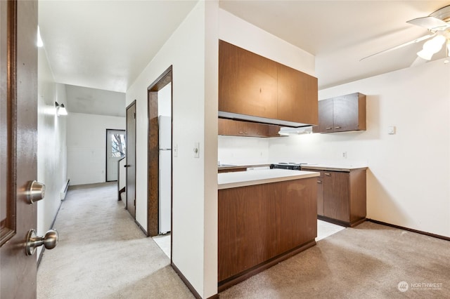 kitchen with white refrigerator, light colored carpet, and ceiling fan