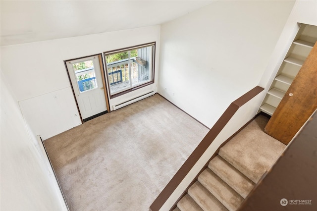 spare room featuring a baseboard radiator, vaulted ceiling, and carpet flooring