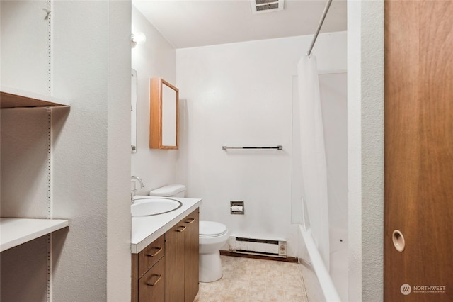 bathroom featuring vanity, a baseboard heating unit, and toilet