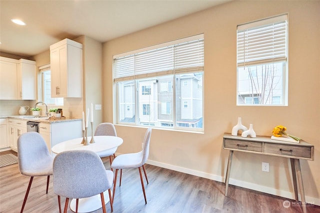 dining space featuring sink and light hardwood / wood-style floors