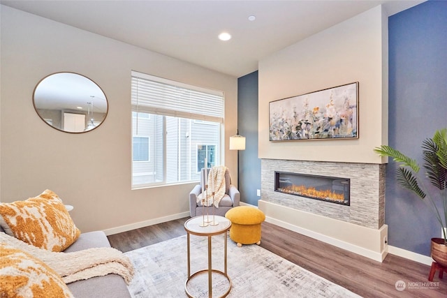 sitting room featuring a fireplace and wood-type flooring