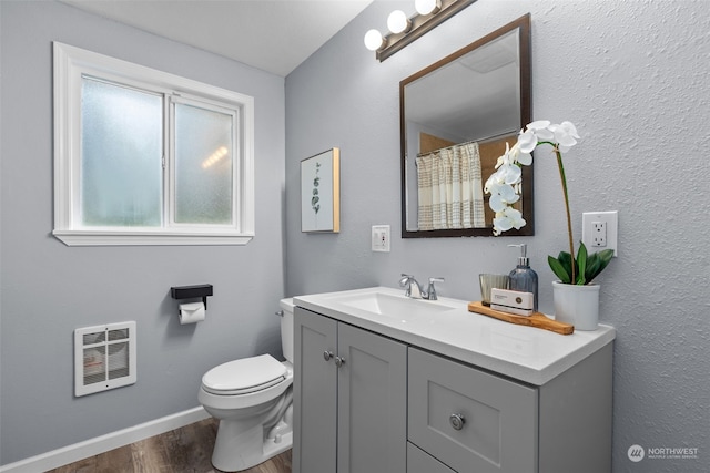 4626 143rd St E, Tacoma, WA 98446 - bathroom featuring wood-type flooring, vanity, heating unit, and toilet