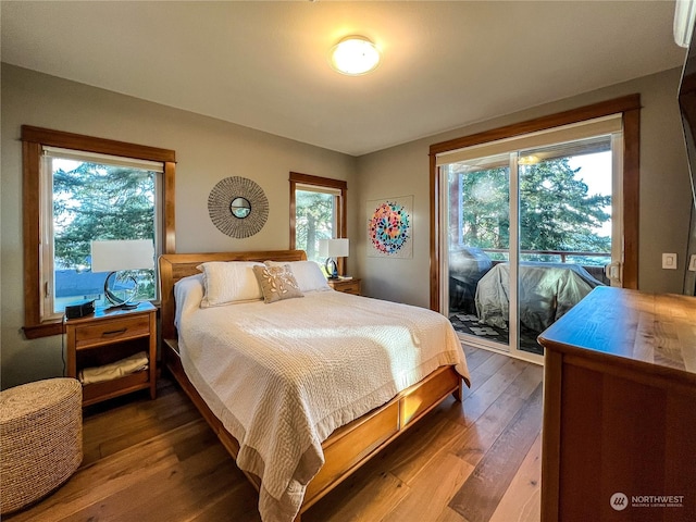 bedroom featuring access to exterior and hardwood / wood-style flooring