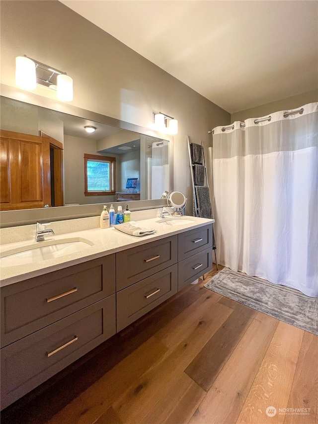 bathroom featuring hardwood / wood-style flooring and vanity