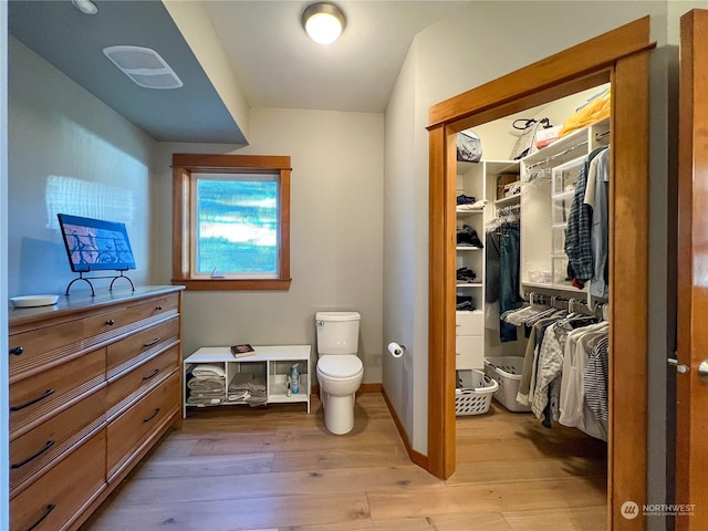 bathroom with hardwood / wood-style floors and toilet