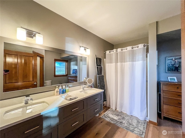 bathroom featuring hardwood / wood-style floors, toilet, vanity, and a shower with curtain