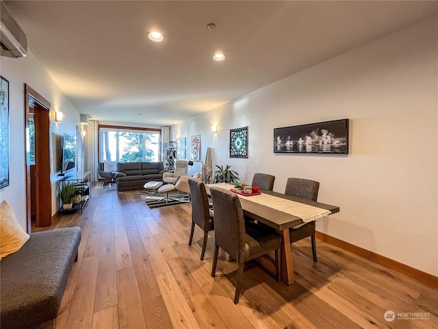 dining space with hardwood / wood-style floors