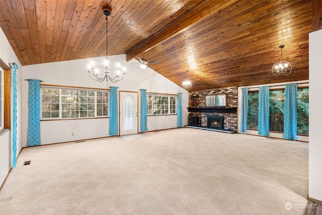 unfurnished living room featuring ceiling fan with notable chandelier, high vaulted ceiling, a fireplace, beamed ceiling, and carpet flooring