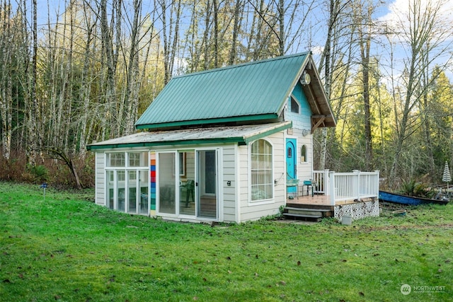 exterior space featuring an outdoor structure, a yard, and a deck