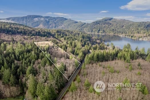 drone / aerial view with a water and mountain view