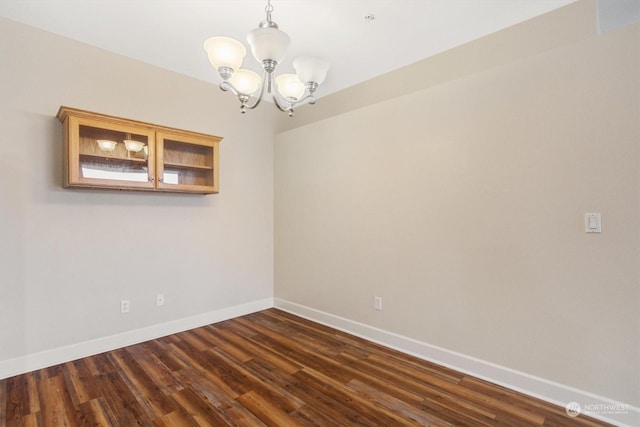 1548 River Rd Unit 209, Longview, WA 98632 - spare room with a notable chandelier and dark hardwood / wood-style flooring