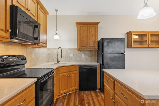 1548 River Rd Unit 209, Longview, WA 98632 - kitchen featuring decorative backsplash, dark hardwood / wood-style flooring, sink, black appliances, and pendant lighting