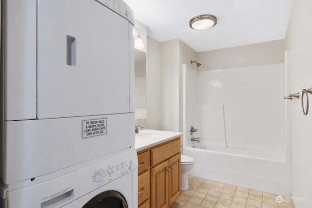 1548 River Rd Unit 209, Longview, WA 98632 - full bathroom featuring vanity, tile patterned flooring, toilet, stacked washer / drying machine, and tub / shower combination