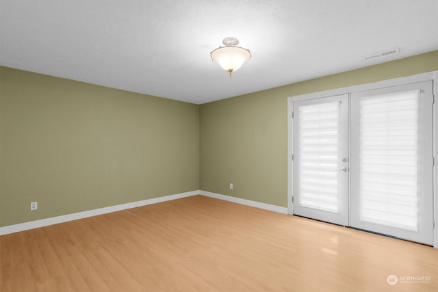 spare room with light hardwood / wood-style flooring