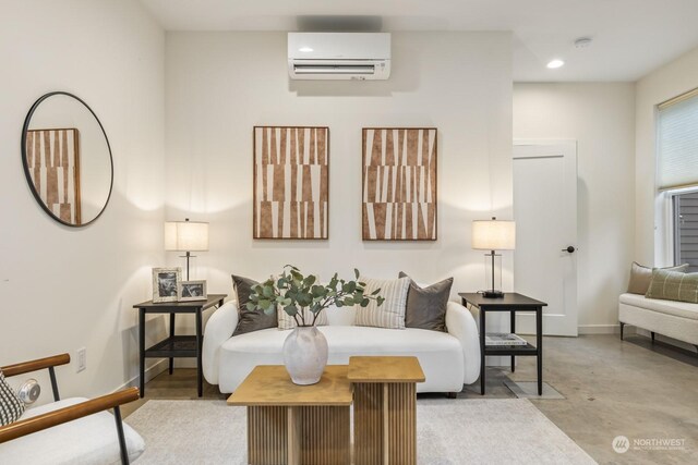 living room with concrete floors, recessed lighting, baseboards, and a wall mounted air conditioner