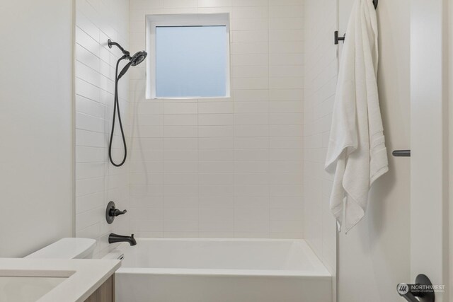 bathroom featuring vanity, toilet, and tub / shower combination