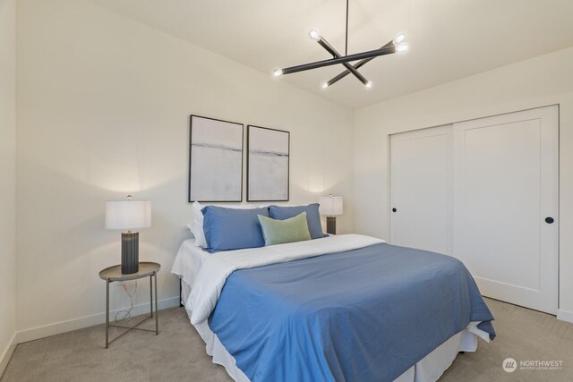 bedroom with a closet, baseboards, and light colored carpet