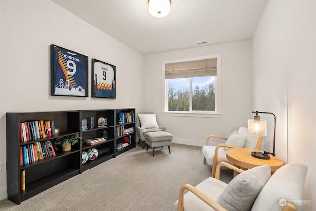 sitting room featuring carpet flooring