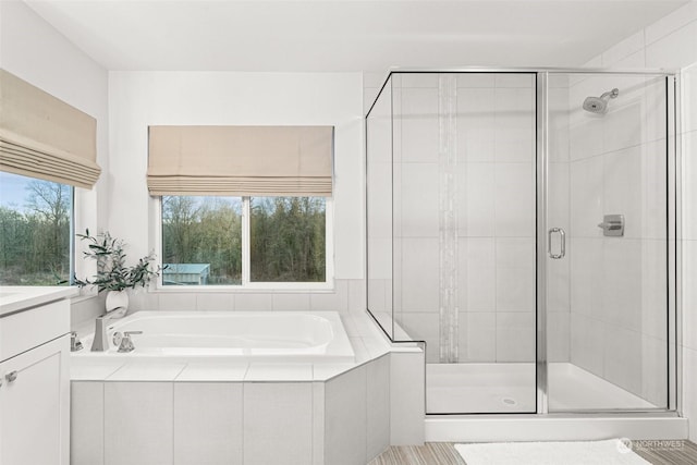 bathroom with vanity and independent shower and bath