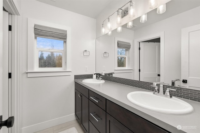 bathroom with tile patterned floors, vanity, and tasteful backsplash