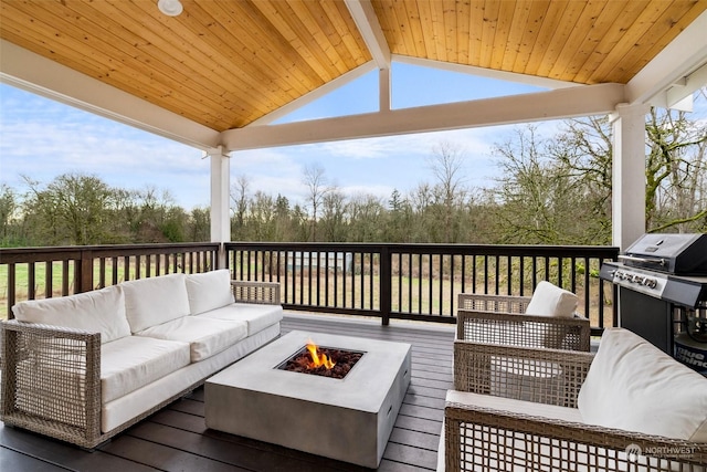 wooden deck with an outdoor living space with a fire pit and a grill