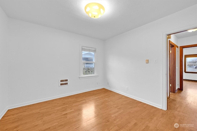 unfurnished room with light hardwood / wood-style floors and heating unit