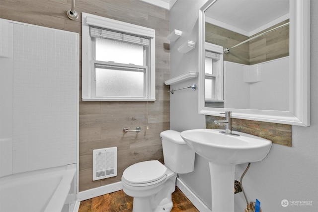 bathroom featuring a shower, hardwood / wood-style floors, and toilet