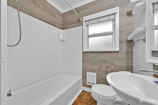 full bathroom with sink, washtub / shower combination, tile walls, and toilet