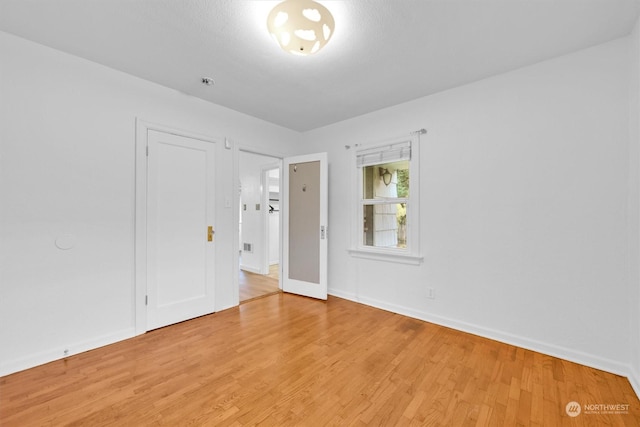 unfurnished room featuring light hardwood / wood-style floors