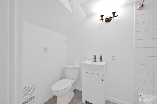 bathroom with vanity, toilet, and vaulted ceiling