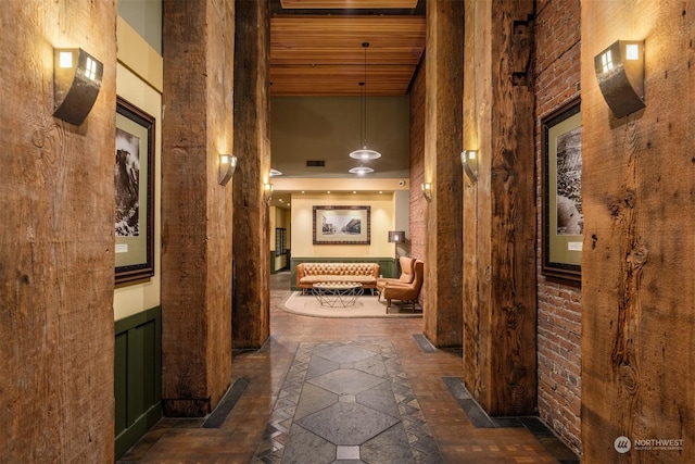 hall featuring wooden ceiling and a towering ceiling