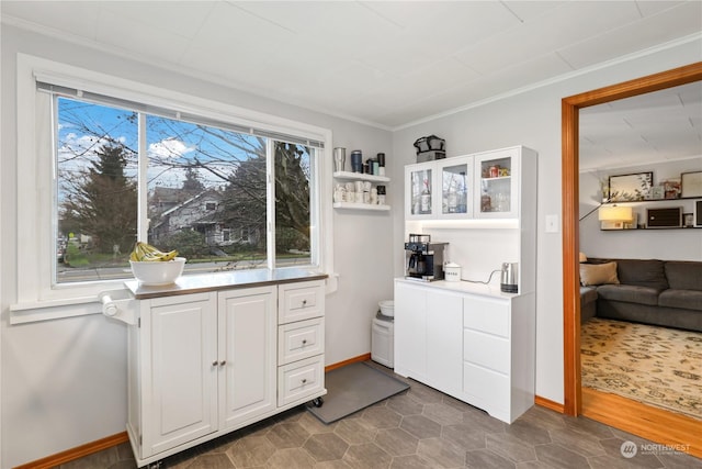 1207 W Pioneer, Puyallup, WA 98371 - laundry room featuring dark tile patterned floors and ornamental molding