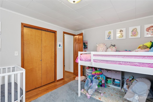 1207 W Pioneer, Puyallup, WA 98371 - bedroom featuring a closet, light hardwood / wood-style floors, and ornamental molding