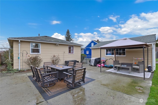 1207 W Pioneer, Puyallup, WA 98371 - back of house featuring an outdoor living space with a fire pit, a patio, and a gazebo