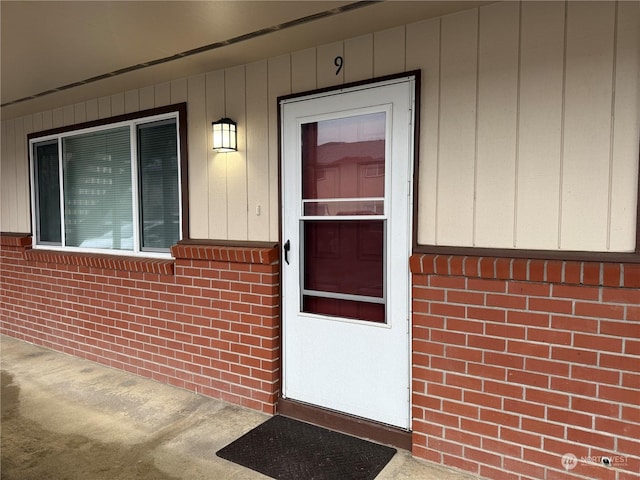 view of exterior entry featuring covered porch