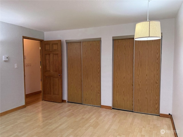 unfurnished bedroom with light wood-type flooring