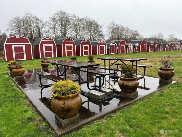 surrounding community with a lawn and a shed