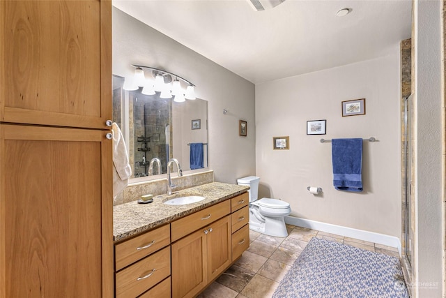 bathroom featuring toilet, vanity, tile patterned floors, and an enclosed shower