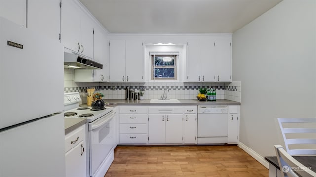 kitchen with white cabinets, white appliances, sink, and light hardwood / wood-style flooring