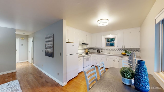 kitchen with white cabinets, light wood-type flooring, white appliances, and sink